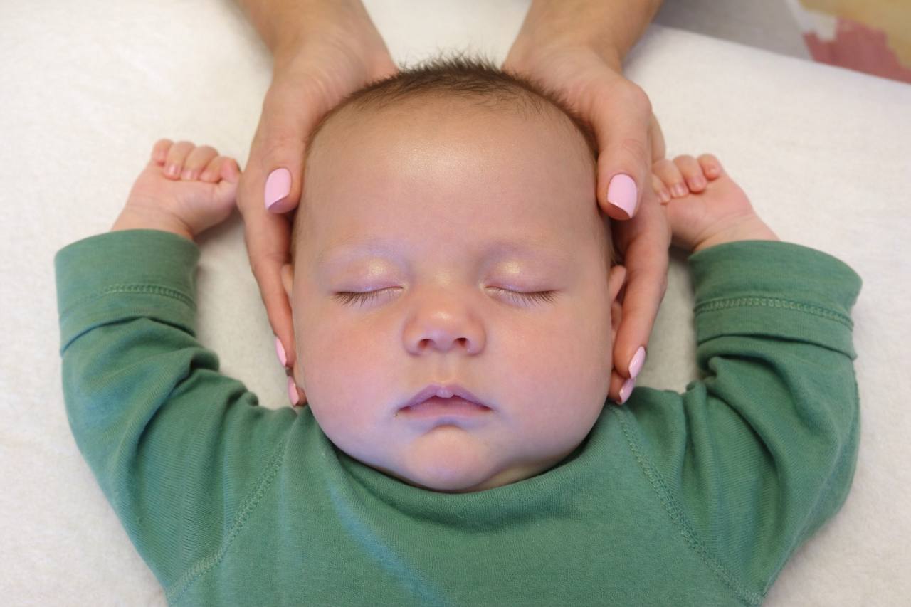 Gentle osteopathic treatment for an infant